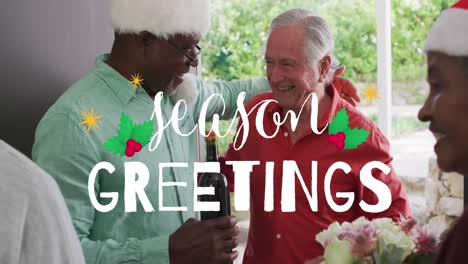 animation of season greetings text over happy diverse senior male friends hugging at christmas party