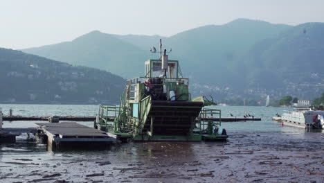 Boat-floating-in-dirty-waters-in-lake-Como