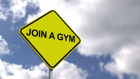 join a gym sign against blue sky