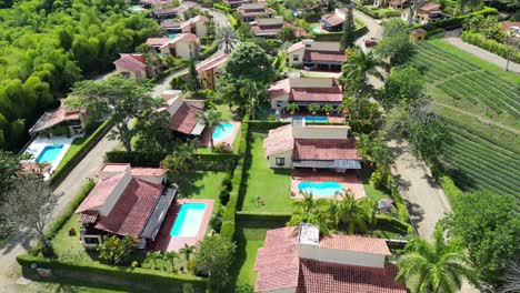 aerial view of fincas with trees and pools close to panaca in quindio colombia