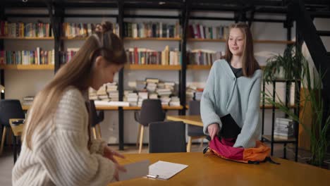 teenage students preparing for study session in library