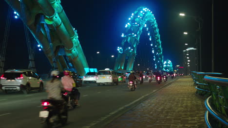 vehicles crossing through dragon bridge in da nang city of vietnam built over han river at night