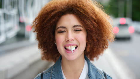 portrait of an edgy girl with afro blowing bubble