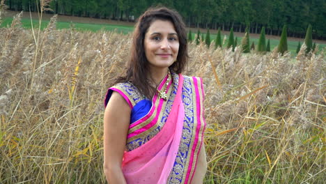 beautiful girl looking at the camera in a wheat field