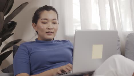 아시아 비즈니스 여성은 노트북을 사용하여 온라인으로 집에서 일합니다