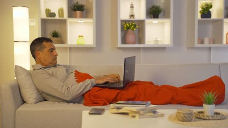 Man-using-laptop-while-lying-down.