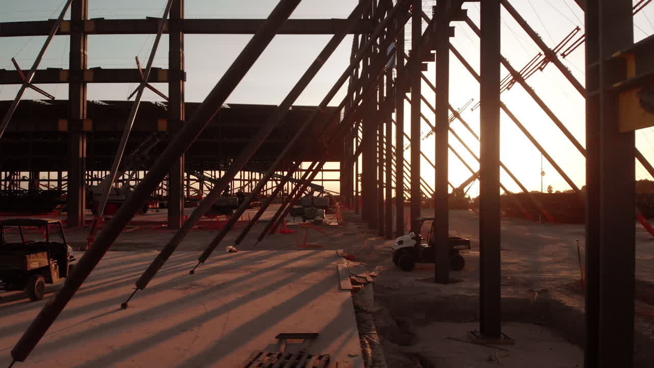 Ground-based drone shot on a steel construction project on a sunny afternoon