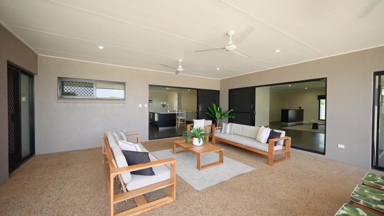 Large modern home exterior patio with comfortable seating and stylish outdoor design.