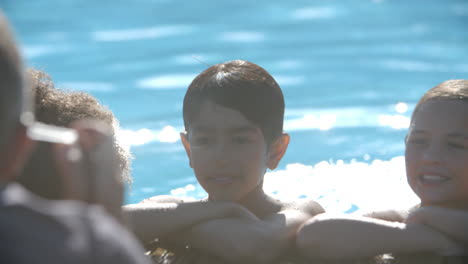 photographer taking picture of children in swimming pool