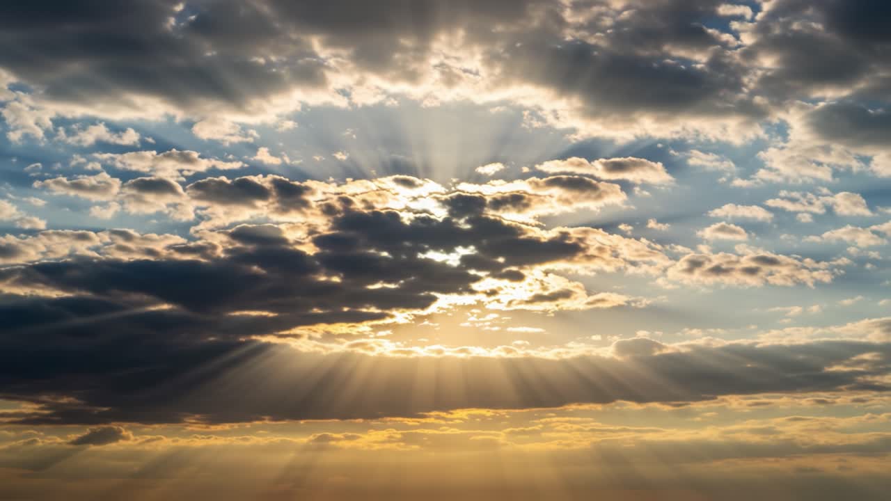 A Stunning Sunset: Rays of Sunlight Break Through the Clouds, Creating a Breathtaking Natural Artwork in the Sky Captured by Nature's Brushstrokes