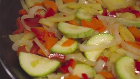 closeup pan left, spanish pisto steaming in frying pan while cooking