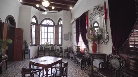 traditional asian room of old antiques in malaysian museum, forward dolly shot