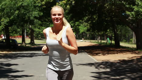 a woman jogs up a small hill towards the camera
