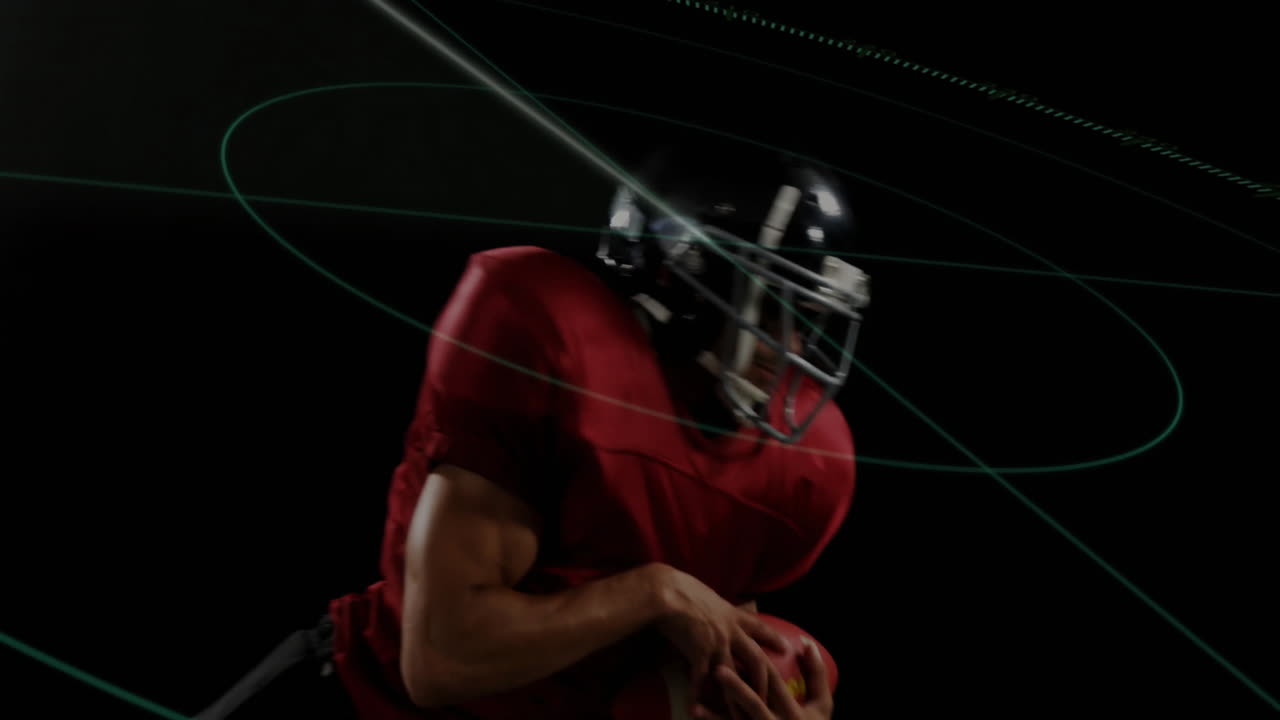 Holding football with digital lines overlay, American player in red jersey