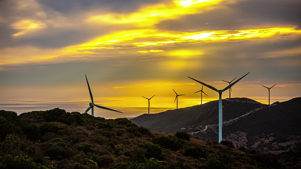 Wind farm on the southern coast of Spain at sunset - time lapse