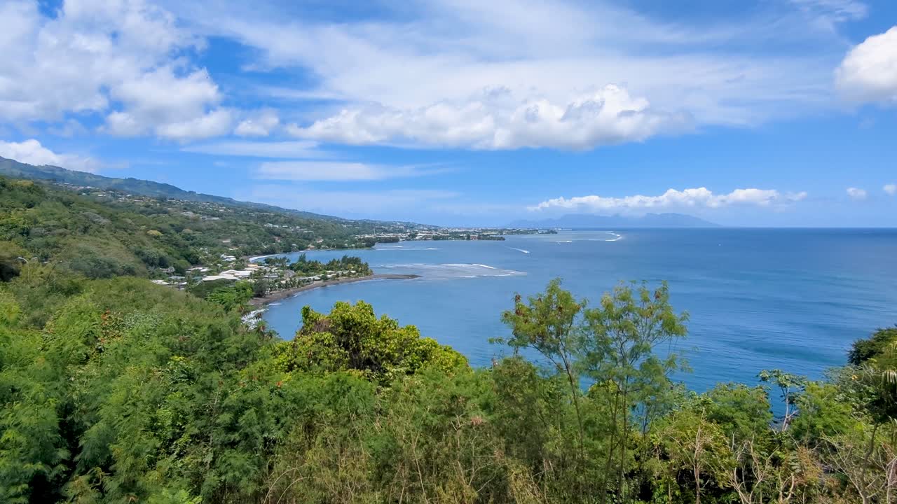 Scenic pan of Papeete with ocean views and coral reef from Belvédère du Tahara'a lookout point in Tahiti, French Polynesia, South Pacific