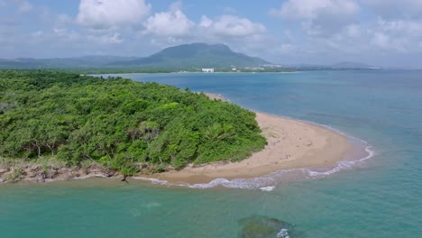 stunning aerial view of punta bergatín in puerto plata on a sunny day, capturing the golden beach, lush vegetation, and vibrant coastal landscape