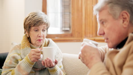 Couple,-talking-and-together-with-coffee-in-living