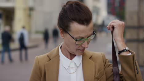 portrait confident senior business woman smiling happy enjoying professional urban lifestyle successful middle aged female wearing glasses in city