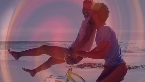 woman riding yellow bicycle while man pushing it on sandy beach at sunset, showing health icons