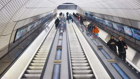 subway station escalators with people