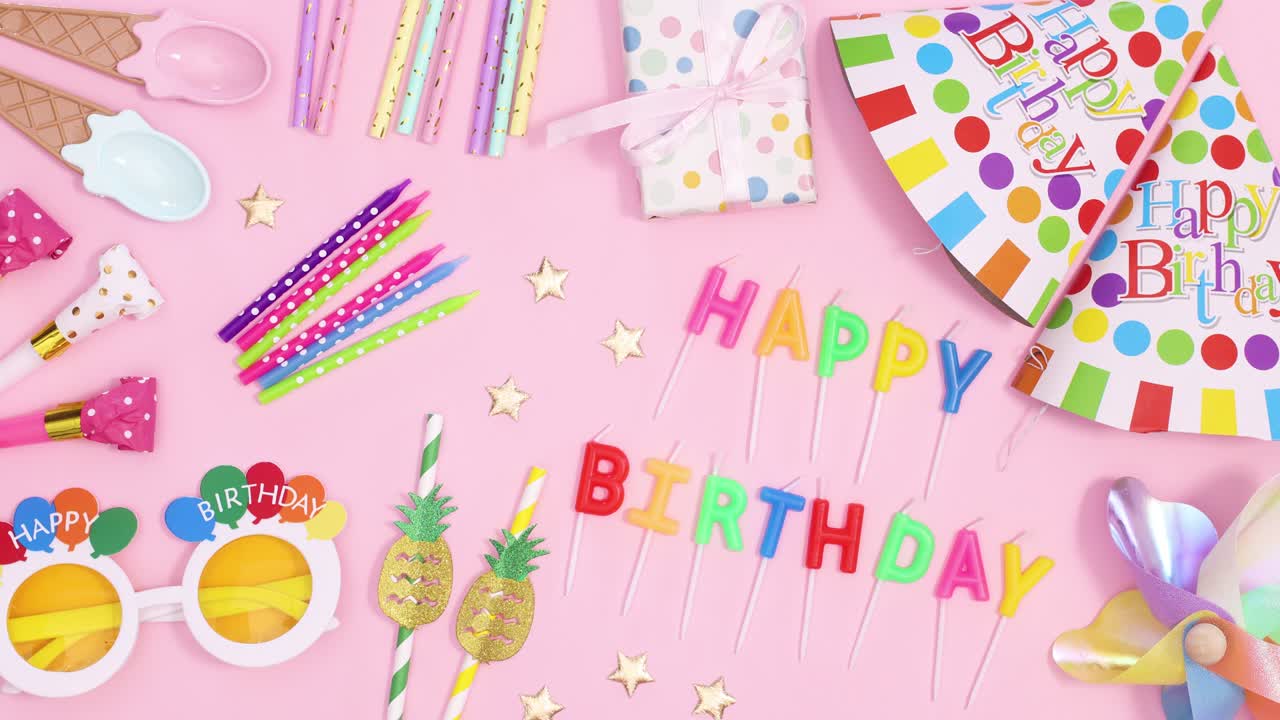 Birthday party accessories move on pastel pink background. Stop motion