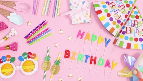 birthday party accessories move on pastel pink background. stop motion