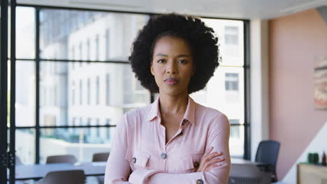 portrait of serious businesswoman standing in empty office