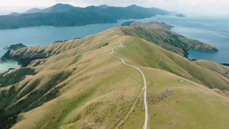 aerial drone view flying over mainland of te aumiti french pass with d'urville island in the distance, marlborough sounds, south island of new zealand aotearoa