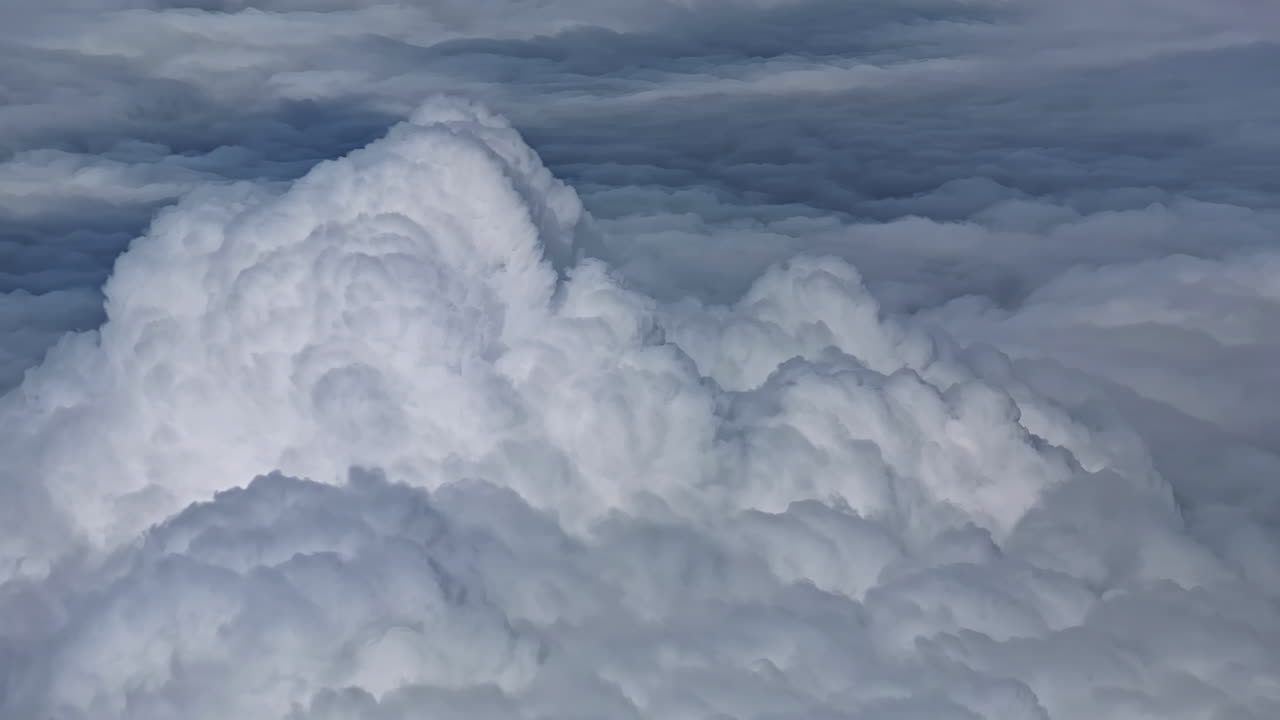 A breathtaking view of fluffy white clouds seen from above while flying over
