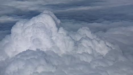 a breathtaking view of fluffy white clouds seen from above while flying over