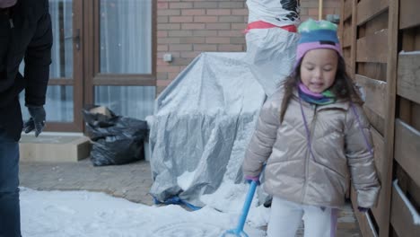 grandfather and granddaughter having fun in the snow