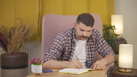 man laughing at phone message.