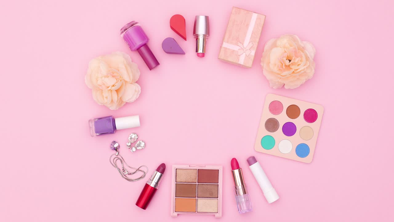 Make up products and accessories blinking in circle on pink theme. Stop motion