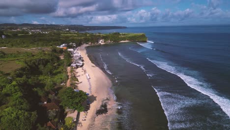 bird eye view of balangan beach and waves crashing the sand - uluwatu, bali - indonesia