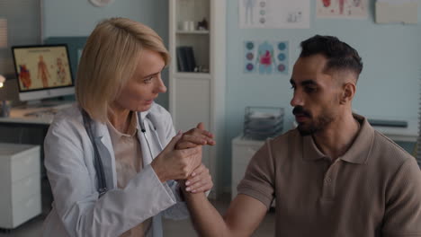 doctor examining patient's wrist