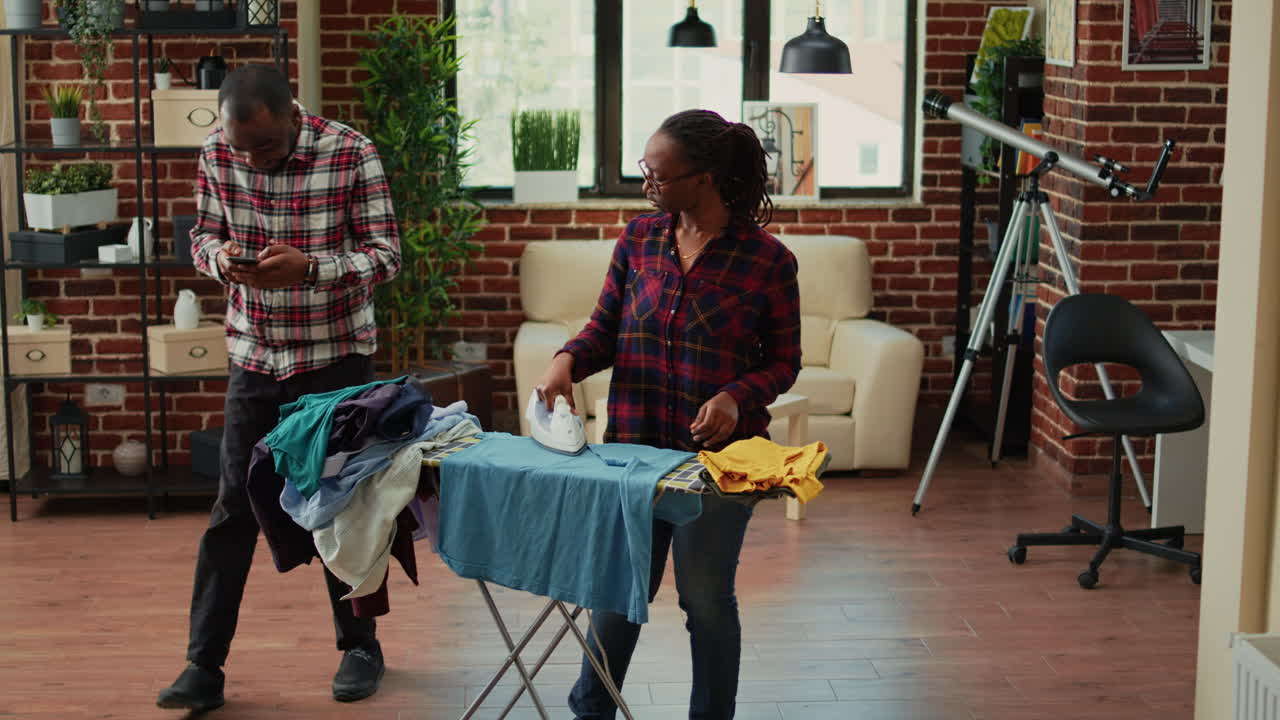 Tired modern wife ironing laundered clothes