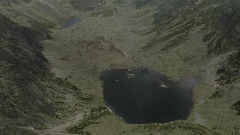 wonderful view of mountain range near at skok waterfall and hruby vrch high tatras on a sunny day in slovakia - aerial shot