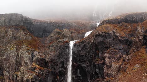 Drone-panning-down-on-remote-waterfall-in-Iceland