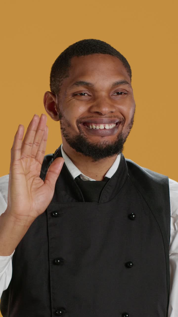 African American Chef Smiling and Waving in Studio