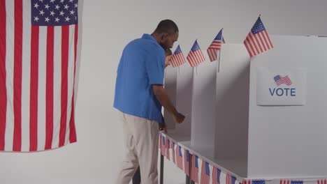 Man-Walking-Into-Booth-With-Ballot-Paper-To-Cast-Vote-In-American-Election-In-Slow-Motion