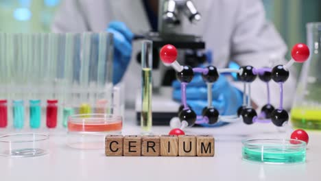 cerium element display in a science laboratory with a chemist working
