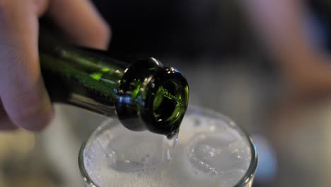 Pouring-sparkling-wine-into-cocktail,-close-up