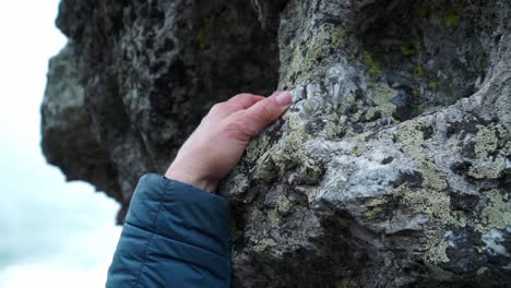 person climbing a rocky outcrop