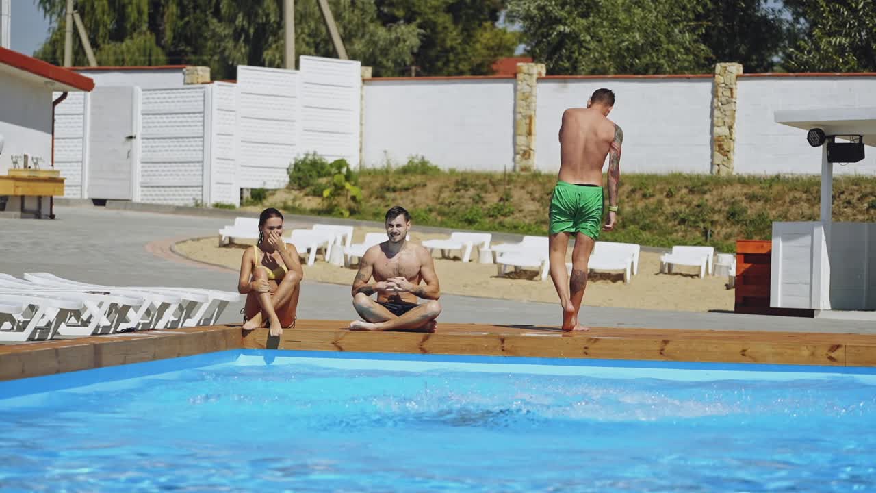 Woman jumping into swimming pool. Excited female jumping in pool at resort