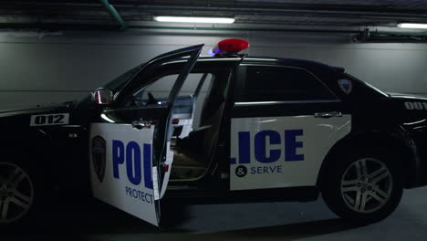 Police-car-parking-at-construction-building.-Patrol-vehicle-with-open-doors