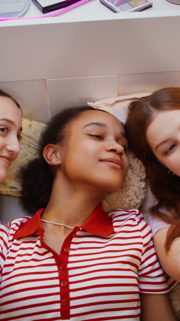 Teenage girls taking a selfie together