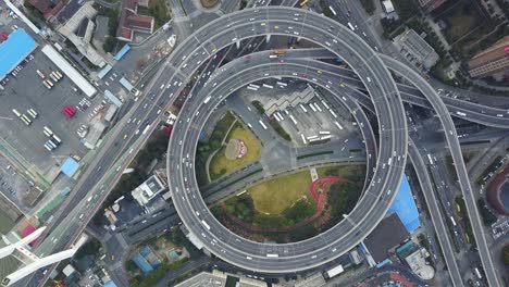 nanpu bridge in shanghai china nanpu da qiao cable-stayed bridge aerial footage top down of passing traffic on elevated circular on off ramp sped up 40x