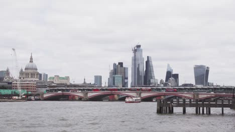 bank - financial district in london full of skyscrapers and famous buildings, thames river in foreground, wide angle static view