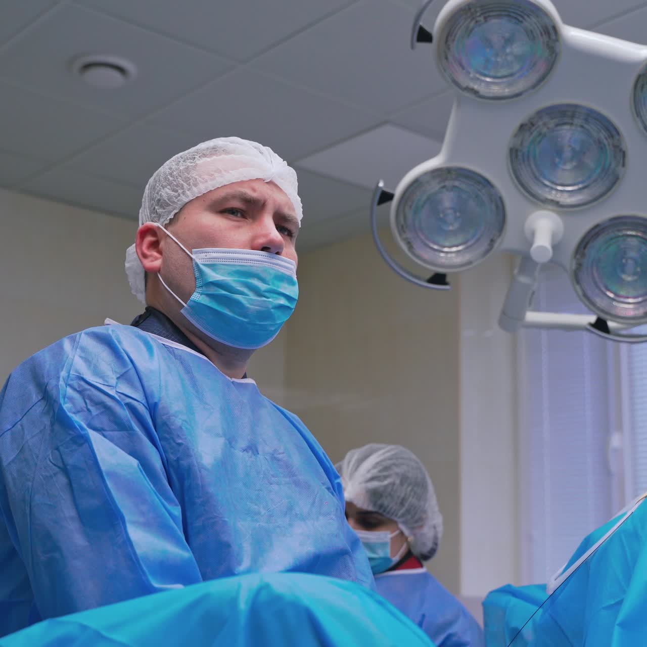 Medical procedure in emergency room. Surgical team performing surgery in modern operation theater